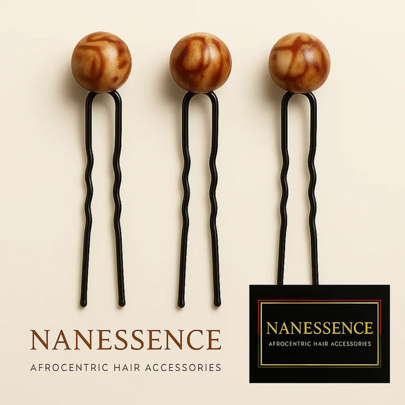 Set of three Afrocentric hair pins with decorative brown round wooden tops on light background