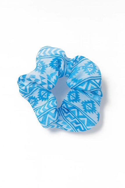 Blue Afrocentric patterned scrunchie on white background