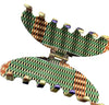 Afrocentric patterned hair claw clip with geometric green, black, orange, and cream design
