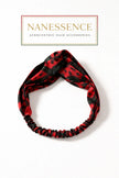 Red and black Afrocentric patterned twisted headband on white background