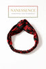 Red and black Afrocentric patterned twisted headband on white background