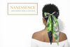 Woman with natural curly hair wearing a large green satin bow hair accessory, back view