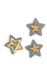 Set of three gray star-shaped hair clips with gold accents on a white background