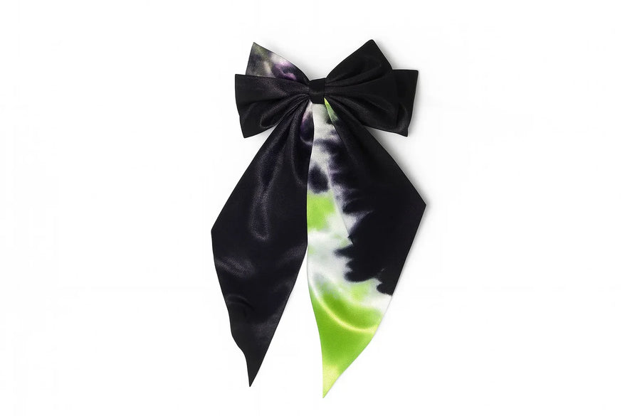 Handcrafted satin bow hair accessory with black, green, and white tie-dye pattern