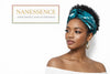 Woman wearing Afrocentric turquoise patterned headwrap and hoop earrings, elegant style