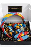 Colorful Afrocentric headband, scrunchie, and hair clips with vibrant geometric patterns in a gift box.