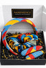 Colorful Afrocentric headband, scrunchie, and hair clips with vibrant geometric patterns in a gift box.