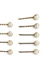 Set of eight gold and black Afrocentric bobby pins with shell-shaped accents on white background.
