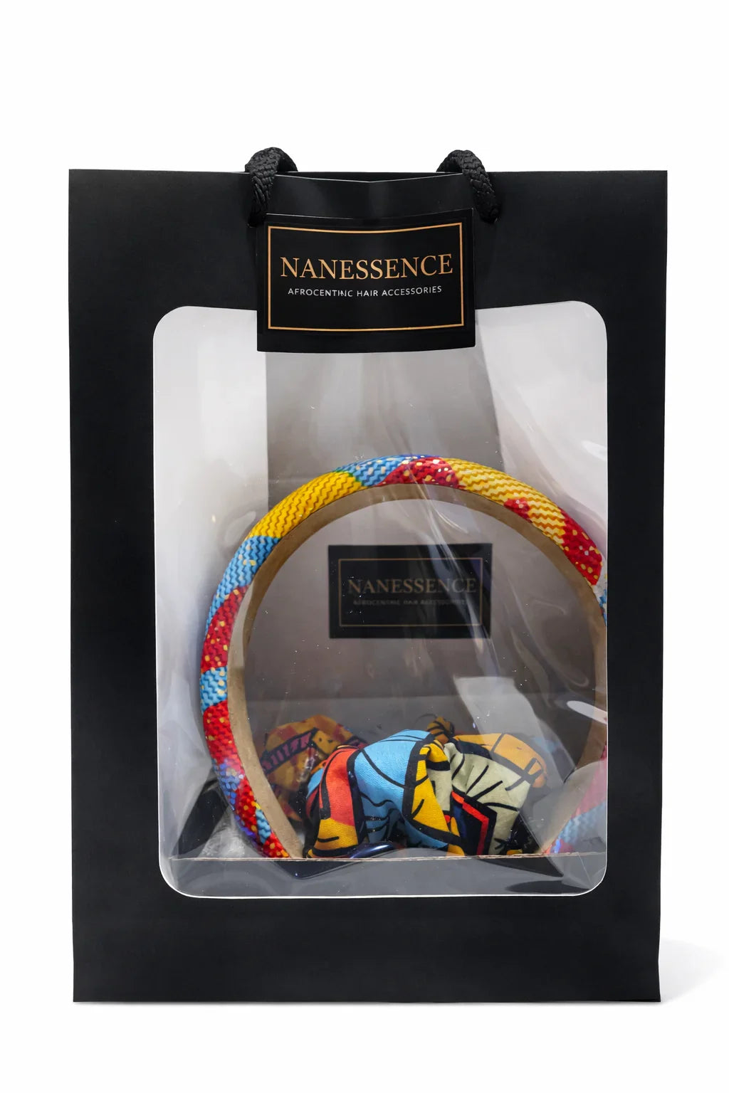 Gift bag with colorful Afrocentric headband and patterned hair accessory inside transparent window