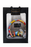 Gift bag with colorful Afrocentric headband and patterned hair accessory inside transparent window