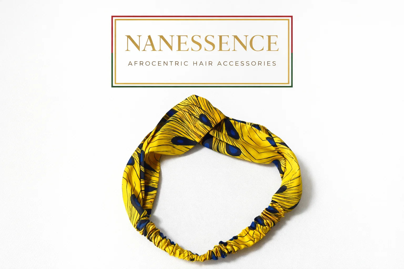 Yellow Afrocentric hairband with blue and black pattern on white background, hair accessories