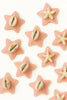 Pink star-shaped accessories with cowrie shells and starfish designs, Afrocentric style