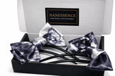 Box with two Afrocentric satin hair bows in black and white tie-dye pattern.