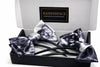 Box with two Afrocentric satin hair bows in black and white tie-dye pattern.