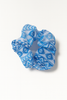 Blue patterned hair scrunchie with geometric Afrocentric design on white background