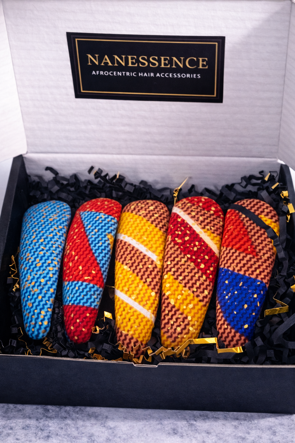 Set of five colorful Afrocentric patterned hair clips in a black gift box