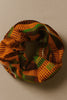 Afrocentric fabric scrunchie with vibrant orange, green, and brown geometric patterns