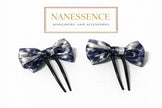 Pair of Afrocentric bow hair forks, blue and silver pattern, on white background