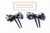Pair of Afrocentric bow hair forks, blue and silver pattern, on white background