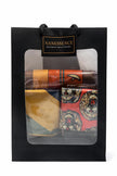 Black gift bag with window displaying colorful Afrocentric hair accessories and patterned scarves