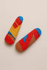Pair of Afrocentric kente-patterned hair clips with bold red, yellow, blue, and brown design