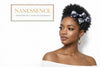 Woman with natural hair wearing two patterned bows, gold hoop earrings, afrocentric hair accessory