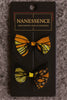 Two Afrocentric butterfly-pattern orange and black hair bows on a display card