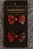 Afrocentric hair accessories set with two patterned fabric bows in red, black, and gold.