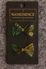 Afrocentric hair bows in green, yellow, and black patterns on display card