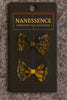 Set of two Afrocentric hair bows with bold yellow and black patterns on display card