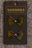Two Afrocentric bow hair clips with bold geometric black and gold patterns on display card.