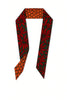 Afrocentric scarf with red floral and orange geometric patterns on a white background