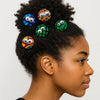 Woman with natural hair adorned with colorful Afrocentric hair pins featuring bold patterns