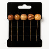 Set of five wooden bead hairpins with Afrocentric design on a black card backing.