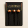 Set of three Afrocentric hair pins with decorative wooden beads on black display card