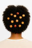Natural afro hair adorned with wooden and carved hair beads, viewed from the back.