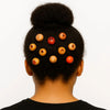 Afro hair bun adorned with handcrafted wooden and red beads, cultural accessories