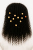 Natural afro-textured hair adorned with carved wooden and ceramic beads on a white background