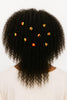Natural Afro hair adorned with colorful African beaded hair accessories, back view