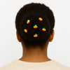 Afrocentric hairstyle with colorful beaded hair accessories in green, yellow, and red