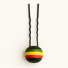 Afrocentric hair pin with green, yellow, and red striped spherical accent