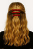 Woman with wavy blonde hair wearing three handcrafted red beaded hair clips
