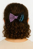 Afrocentric purple and black bow hair accessory with polka dots and geometric print on curly hair