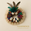 Afrocentric hair accessory with colorful fabric, cowrie shells, feathers, and netted trim.