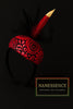 Red and black Afrocentric headband with floral patterns and decorative feathers on black background.
