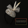Afrocentric headband with patterned fabric, white mesh bow, and decorative feathers