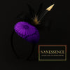 Purple patterned Afrocentric fascinator headband with black mesh bow and black feather accents on dark background