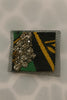 Afrocentric fabric brooch with metallic stones and netting, green yellow black pattern