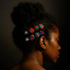 Woman with natural hair wearing colorful Afrocentric patterned hair clips