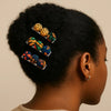 Woman with natural hair wearing colorful Afrocentric fabric hair clips